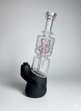 Pink puffco peak glass on a neutral backround