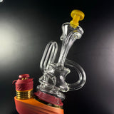 Clear & yellow puffco peak recycler sitting on top of limited edition puffco peak pro