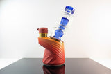 Blue puffco peak glass sitting inside an orange / red Puffco Peak pro “daybreak” 