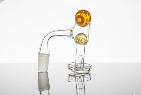 Clear quartz terp slurper paired with 3pce orange marble slurper set on a clear / neutral backround
