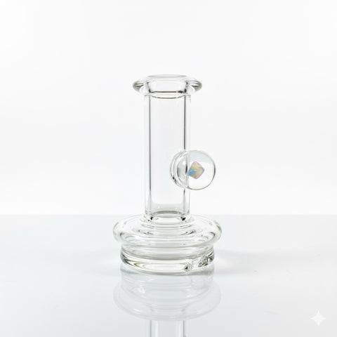 Clear puffco peak dry top replacement glass with an opal on a neutral white backround