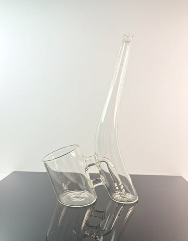 Clear puffco proxy glass on a reflective surface and white neutral backround