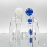 Two terp slurpers on a light backround, one with a white terp slurper set, one with a blue terp slurper set