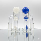 Two terp slurpers on a light backround, one with a white terp slurper set, one with a blue terp slurper set